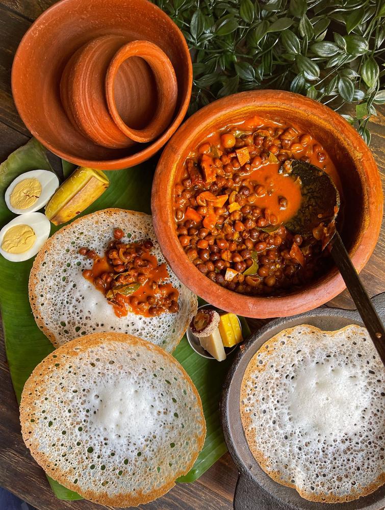 Appam with curry and boiled eggs